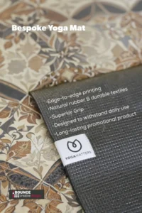 premium custom branded yoga mats featuring a full-colour corporate logo, laid out on a professional studio floor, available from Bounce Creative Designs.