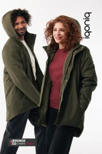 Team members wearing the custom embroidered recycled winter parka from Bounce Creative Designs, featuring multi-colour chest and back branding.
